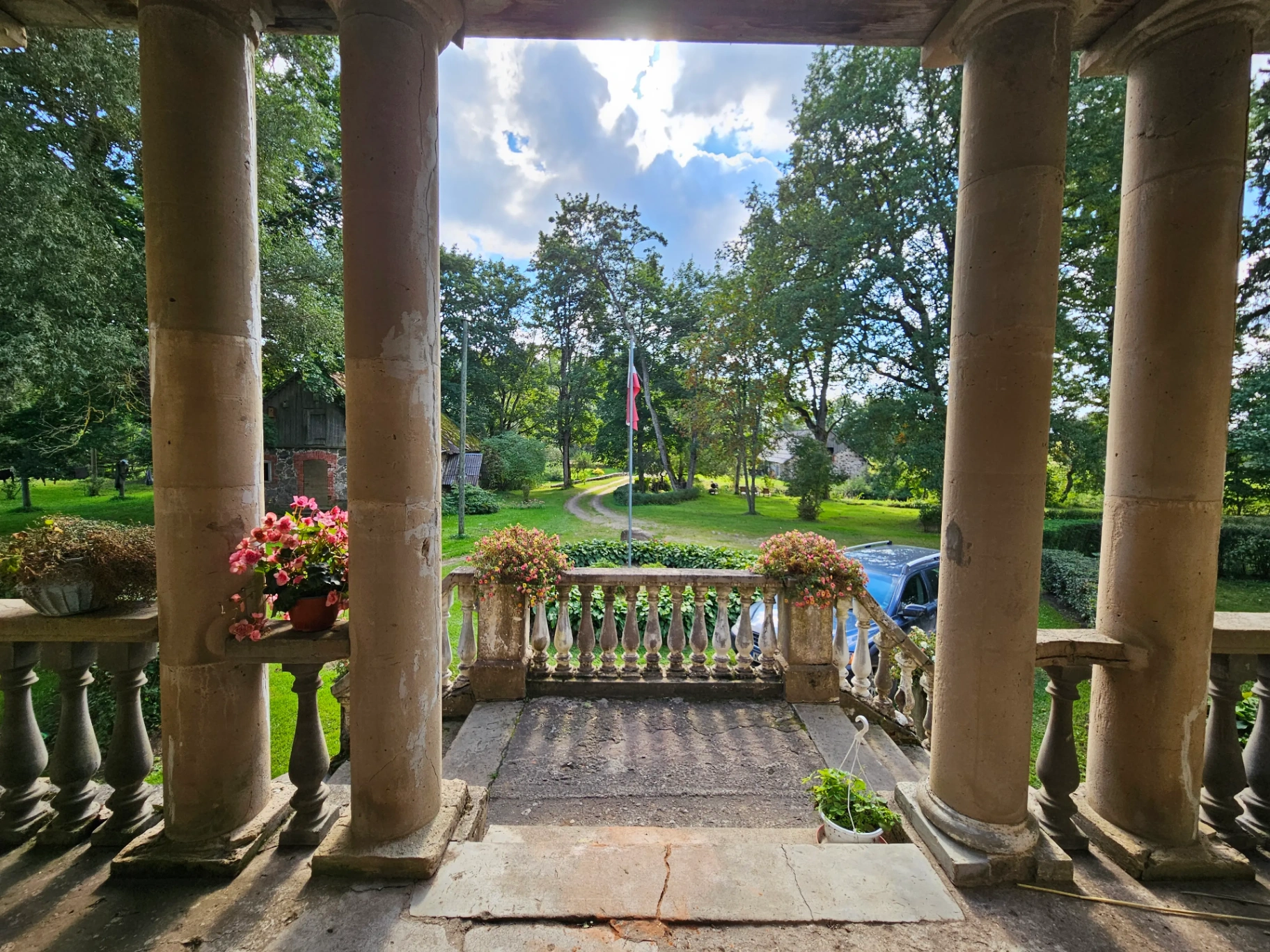 Manor veranda view with columns and garden