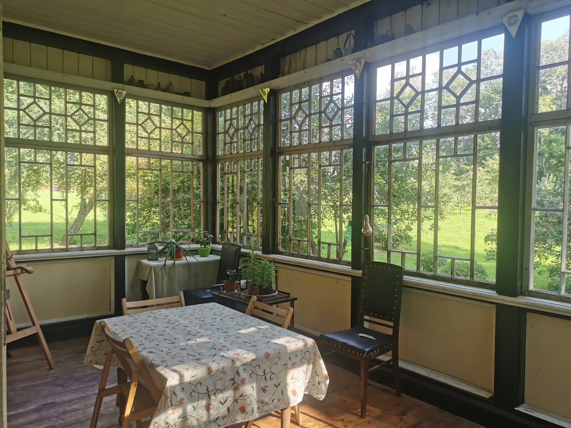 Sun room with Art Deco windows and dining area, overlooking garden
